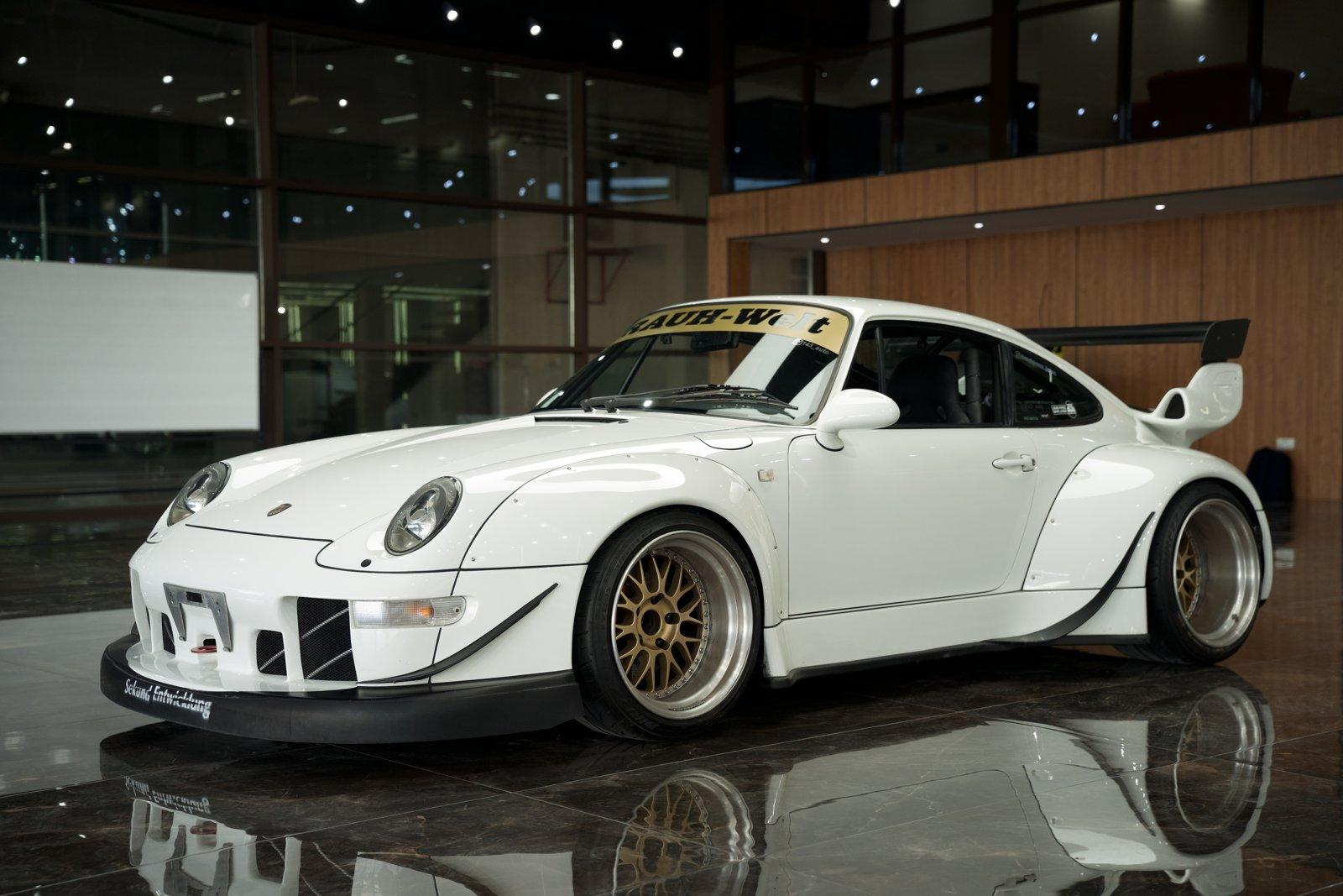 White widebody Porsche 911 on the marble floor of the Sport Cars showroom